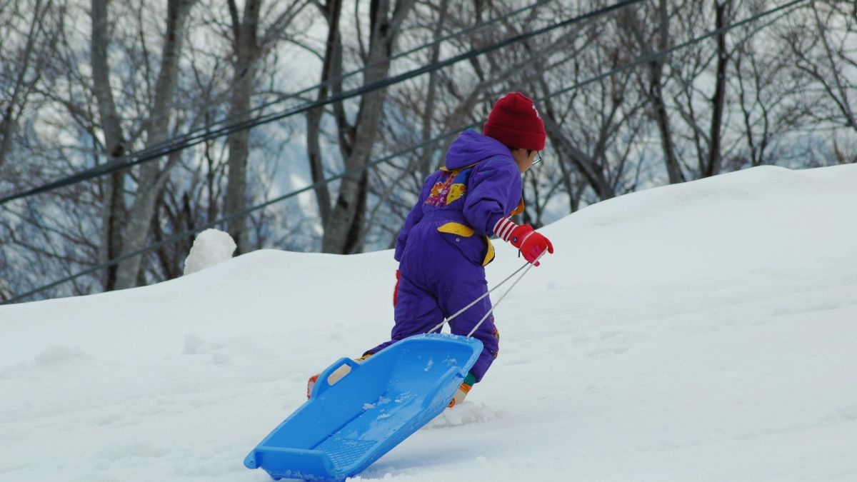 sledder walking uphill